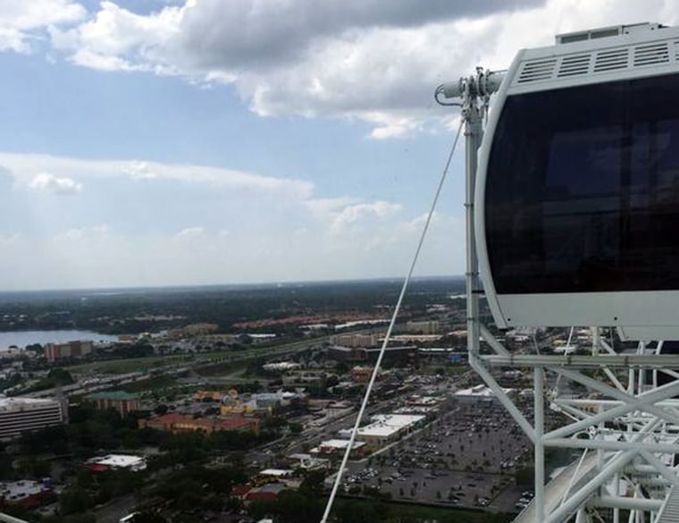 In this photo provided by Makayla Bell, the Ferris wheel known as the Orlando Eye is stopped Friday, July 3, 2015, in Orlando, Fla.