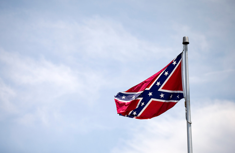 Image: A Confederate flag flies at the base of Stone Mountain