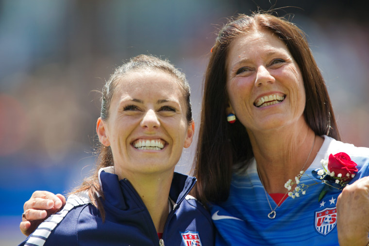 Image: Ali Krieger of the United States gets a hug from her mom, Debbie