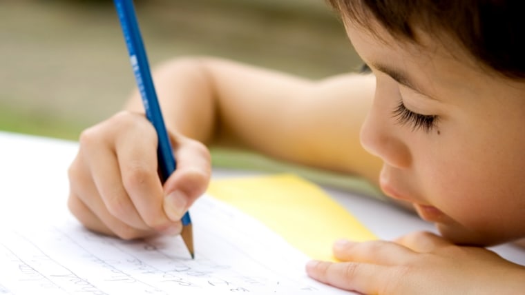 Little boy writing a letter