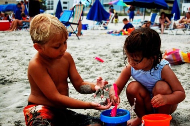 Toddlers playing on the beach.