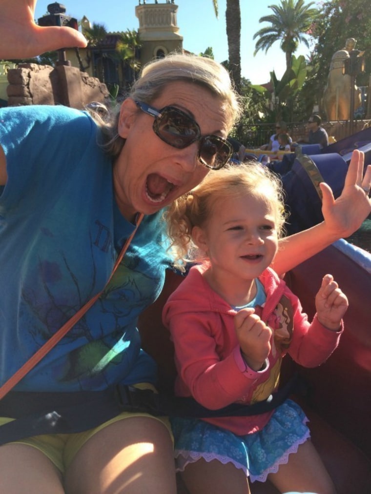 Mom on amusement park ride with toddler
