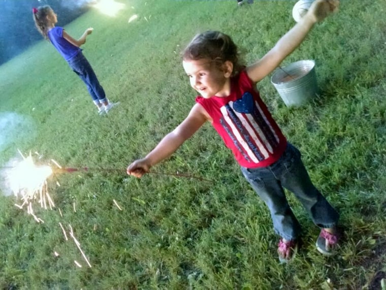"This photo is of my youngest daughter, Olivia. It was her first time getting to hold a sparkler. Her face says it all!"
