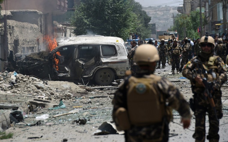 Image: Smoke and flames rise from burning vehicles at the site of a blast in Kabul