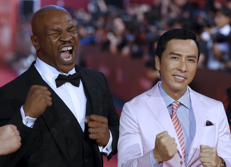 Image: Former heavyweight boxing world champion Tyson and Hong Kong actor Yen arrive at the 18th Shanghai International Film Festival