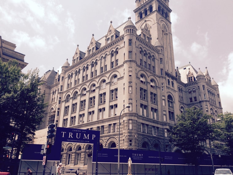 A sign in front of the Old Post Office Pavilion in Washington D.C. announces the coming of a new Trump Hotel.