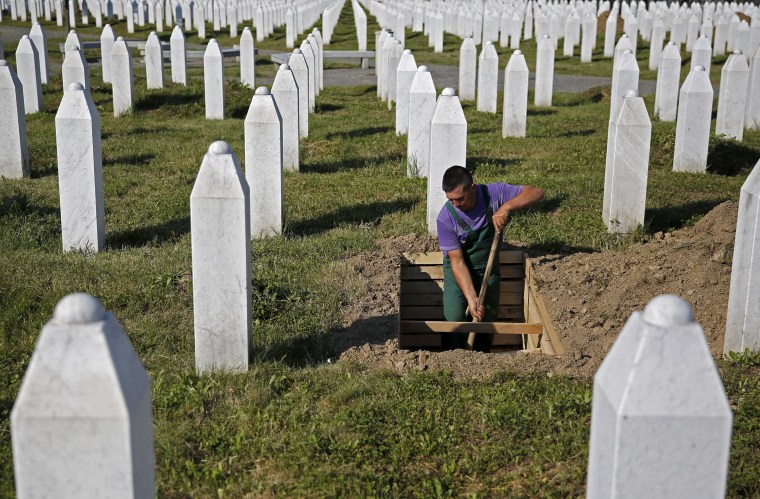 Image: Worker digs grave at a memorial center for Srebrenica massacre victims in Potocari