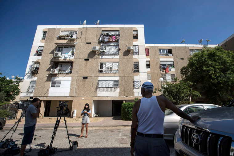 Image: Israeli journalists report outside Avraham Mengisto's apartment building