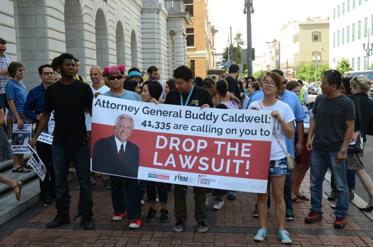 Caption: Members of groups belonging to the Fair Immigration Reform Movement (FIRM) deliver petitions in June 2015 to Lousiana’s Attorney General Buddy Caldwell, who is one of the challengers in a lawsuit filed by 26 states against President Barack Obama’s immigration executive action. The 5th Circuit Appeals court is holding a hearing on the suit. 