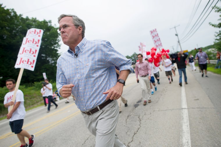 Image: Republican presidential candidate, former Florida Governor Jeb Bush, runs along the Independence Day parade route in Merrimack, New Hampshire