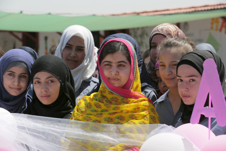 Image: Malala poses with girls for a picture at a school for Syrian refugee girls