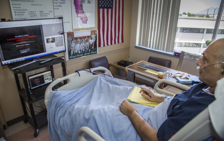 IMAGE: Chuck de Caro running a wargame from his hospital bed