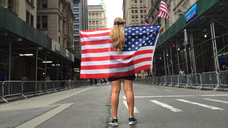 Fan holds flag on Parade route