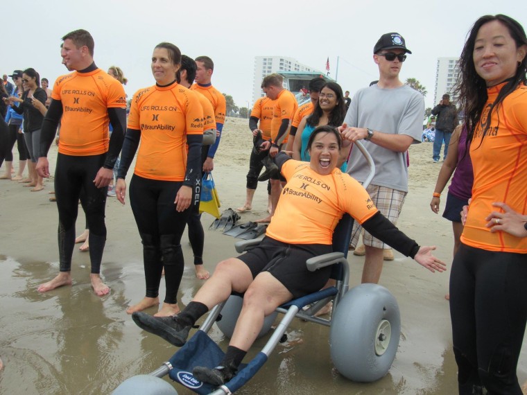 Image: Theresa de Vera surfs for the first time with Life Rolls On.