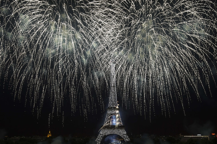 Image: Fireworks light the sky above the Eiffel Tower