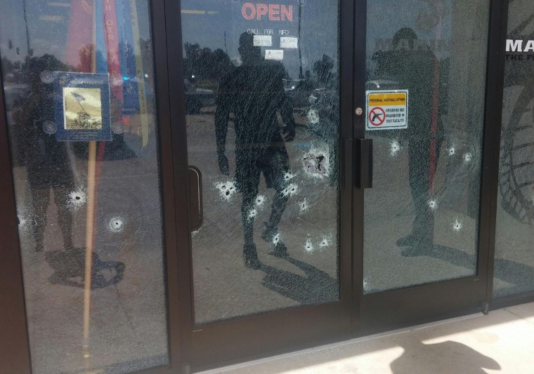 The Armed Forces Career Center through a bullet-riddled door after a gunman opened fire on the building Thursday, July 16, 2015, in Chattanooga, Tenn.