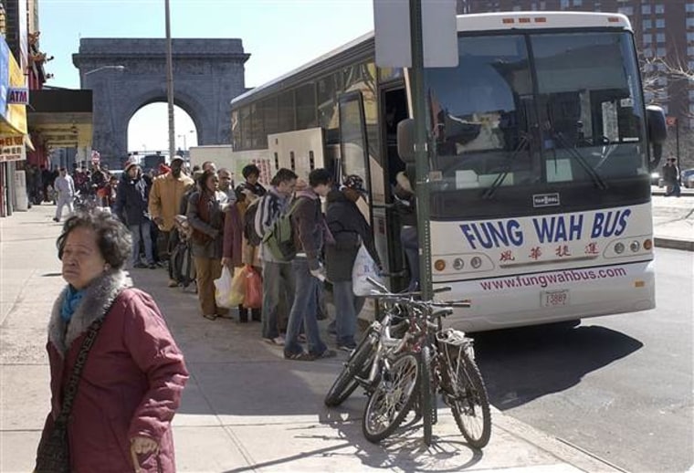 On Canal Street Chinatown in New York City, passengers wait in line for the Fung Wah Bus to Boston.