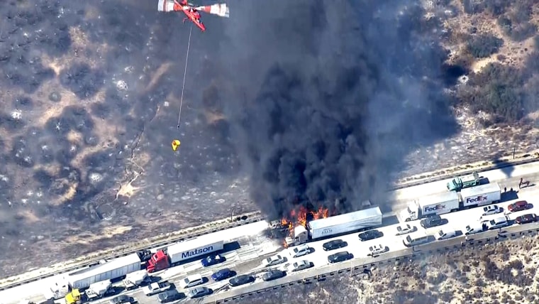 Several cars were in flames after the rapidly-moving brush fire swept over Interstate 15.