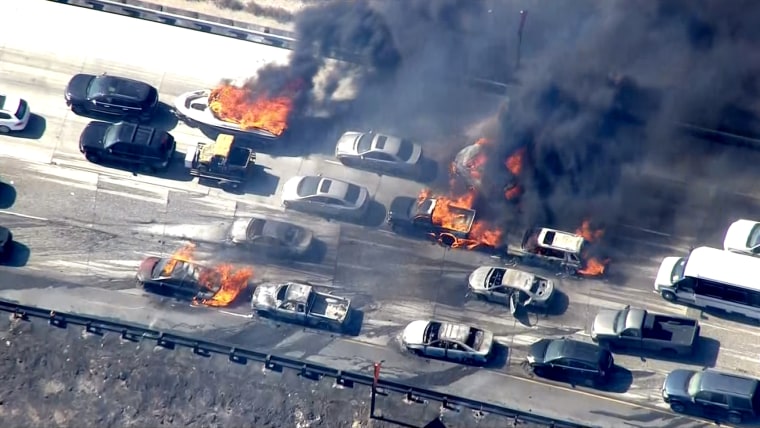 Cars in flames on Interstate 15 after winds drove a wildfire over the highway in San Bernardino County, California.
