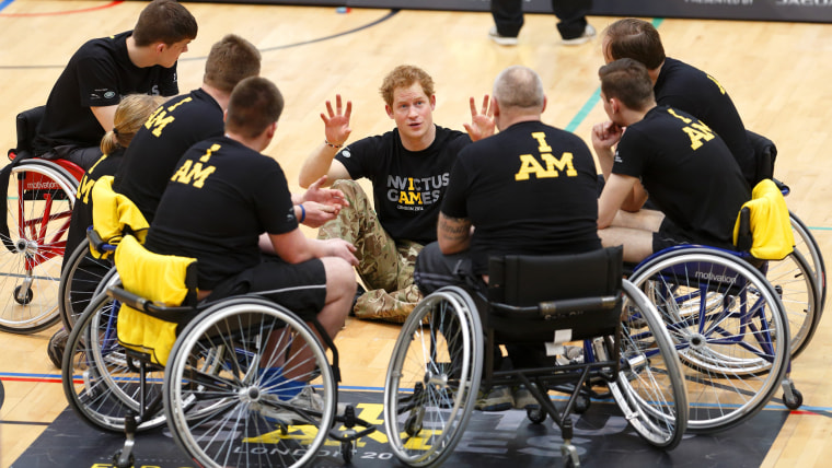 Prince Harry speaks with members of a wheelchair sporting team