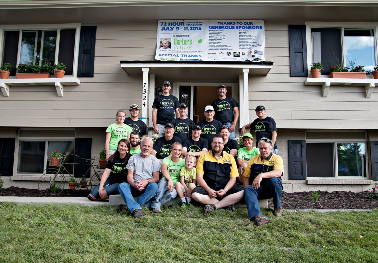 Volunteers pose with the King family outside the home after the remodel was complete.