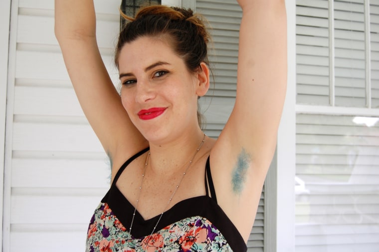 Mary Hartshorn of The Feminist Society of Pensacola shows off her teal armpit hair.
