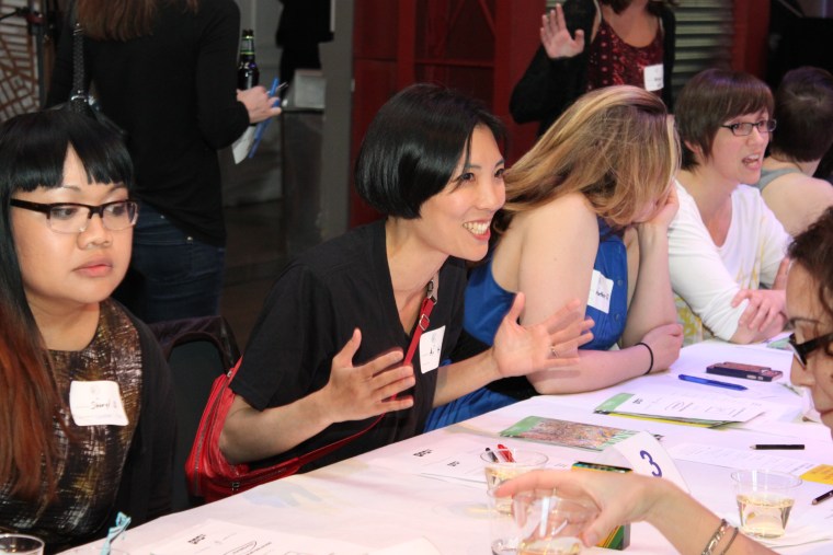 A mom gets excited during her 4-minute "date" with a fellow mom at a Speed Dating for Moms event in Brooklyn, New York.