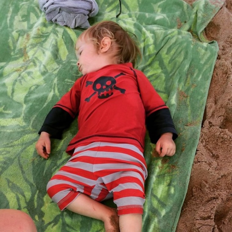 Toddler sleeping at the beach