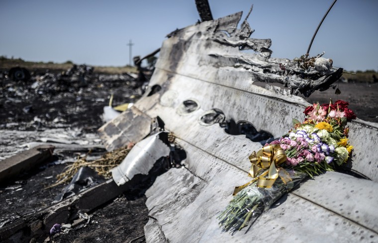 Image: MH17 wreckage and flowers in Hrabove on July 26, 2014