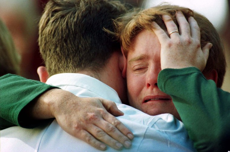 Image: Relatives of the victims shot at Port Arthur comfort each other