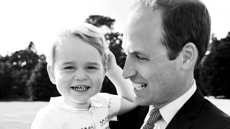 Britain's Prince William holding Prince George