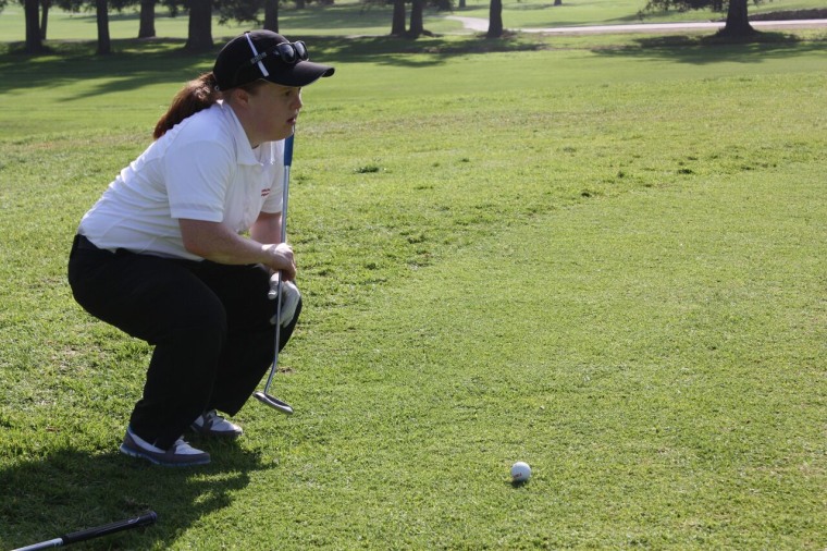 Special Olympics athlete Tess Trojan analyzing the green at the 2015 World Games golf training camp in Los Angeles, California
