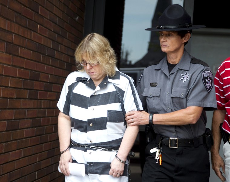 Image: Joyce Mitchell is escorted out of the court house after pleading guilty at Clinton County Court, in Plattsburgh, New York