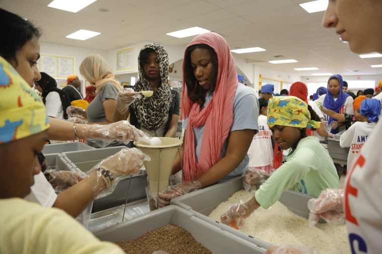 Image: 175 sevadaars in Detroit, Michigan, partnering with Kids Against Hunger, packed over 20,000 meals for the 2014 National Day of Seva.