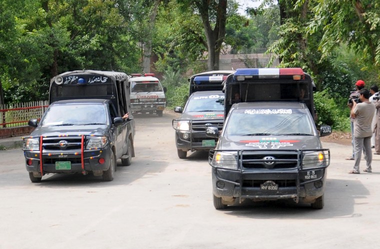 Image: Malik Ishaq's carried in ambulance under police escort
