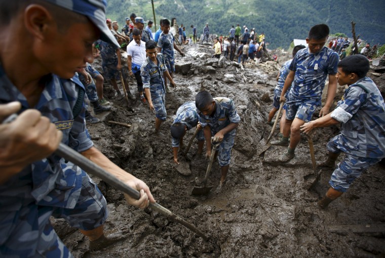 Image: Rescue team members search for landslide victims at Lumle, Nepal