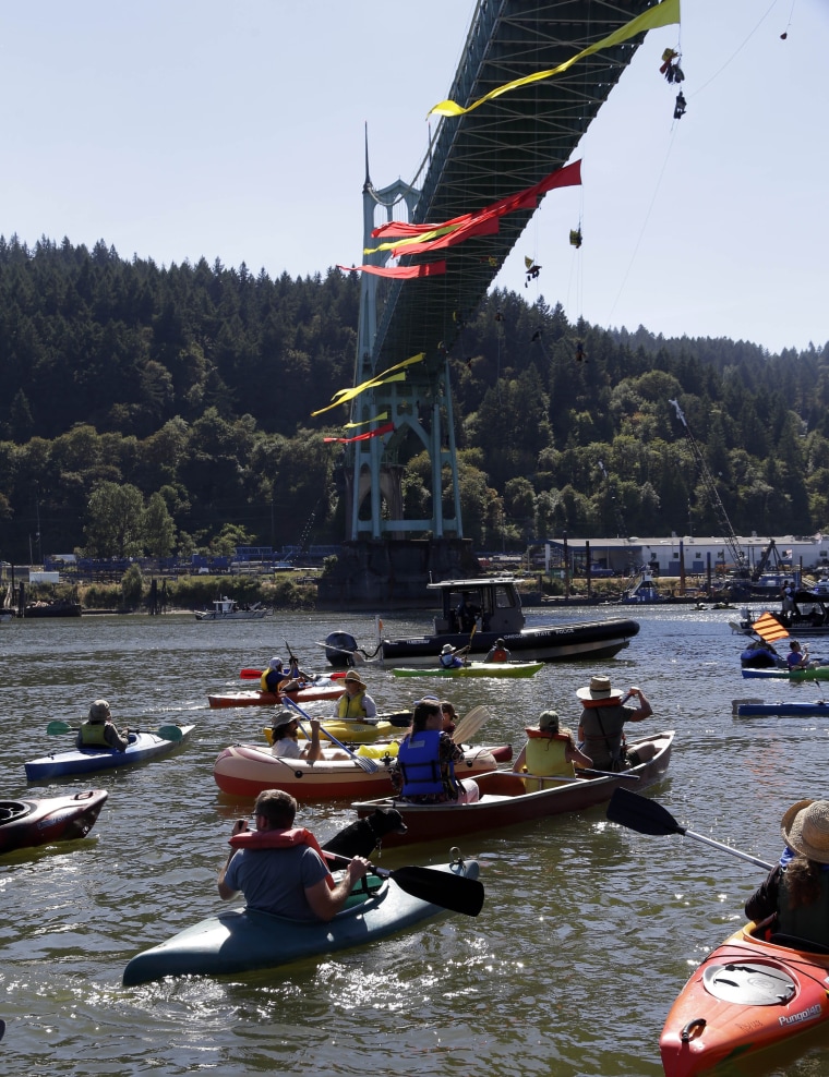 Image: Greenpeace activists hang from Portland bridge