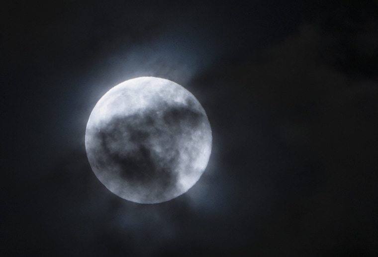 Blue moon seen through the clouds in the sky over Skopje, The Former Yugoslav Republic of Macedonia, 31 July 2015.  