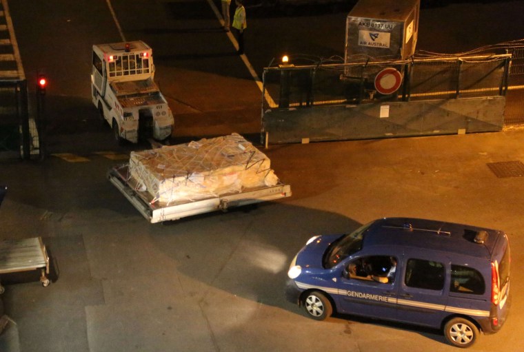 Image: Plane debris is put aboard plane bound for France