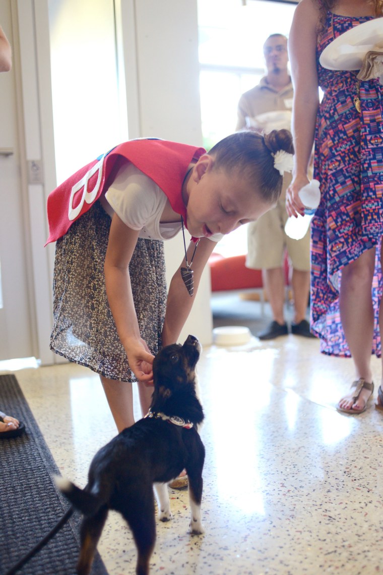 Olivia Saguache, 8, with Sprout, a rescue who had surgery for a cleft lip.