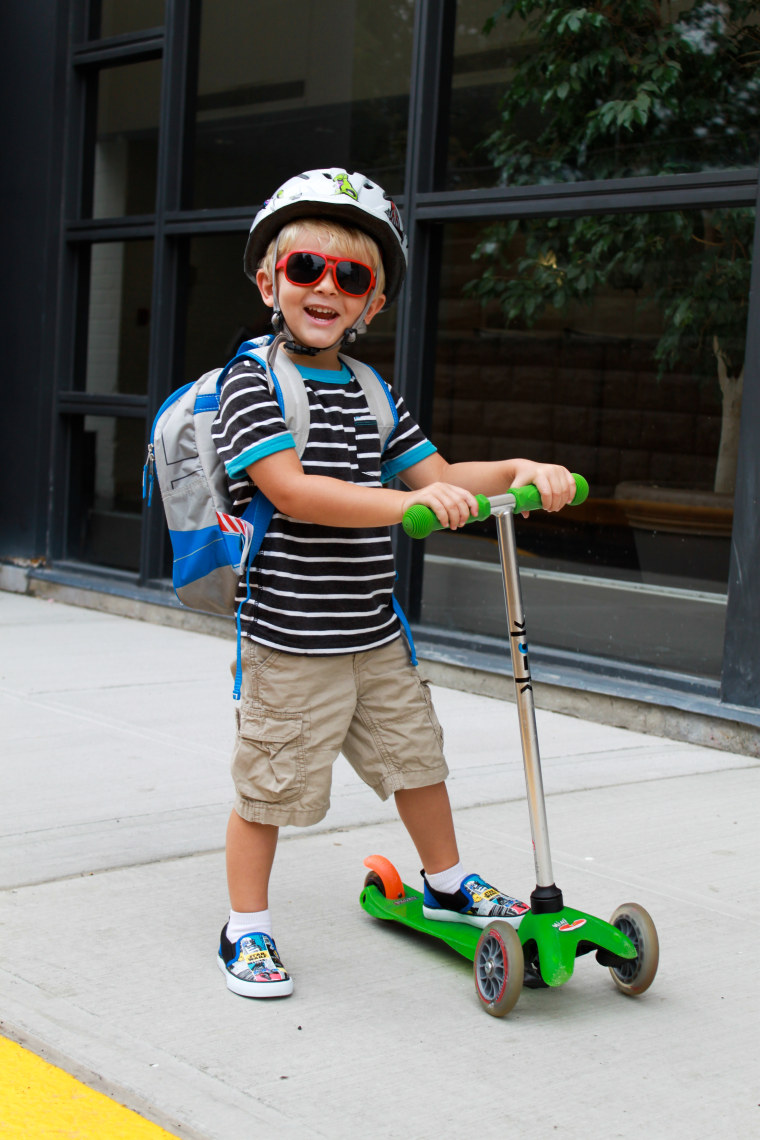 Boy riding scooter to school