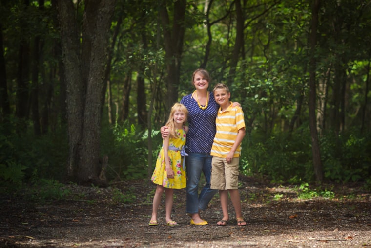 Mom poses with her kids in a back-to-school photo