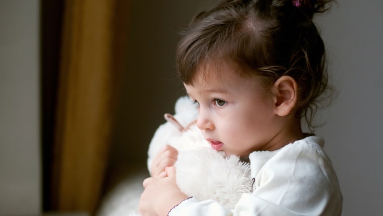 Girl holding teddy bear