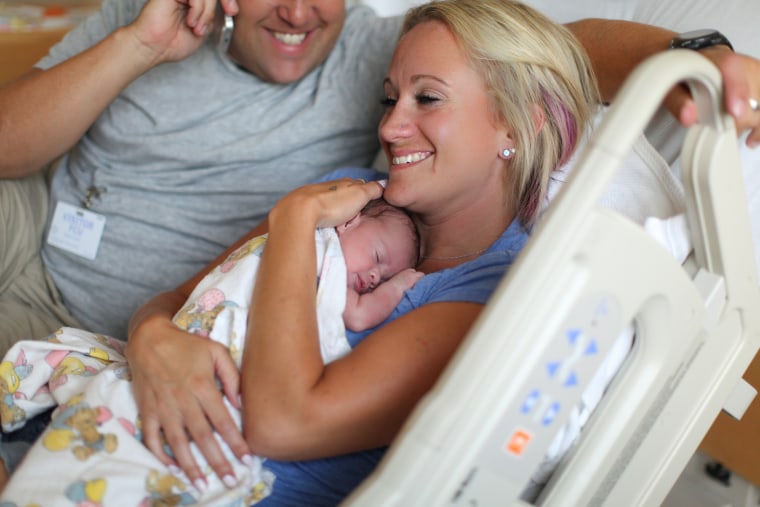 Mom and Dad are all smiles after meeting their new baby girl.