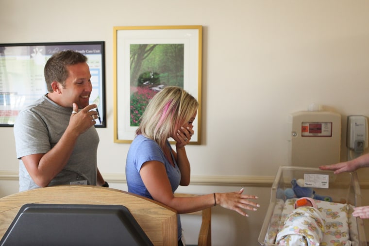 The Olsons are shown approaching daughter Tilly for the first time.