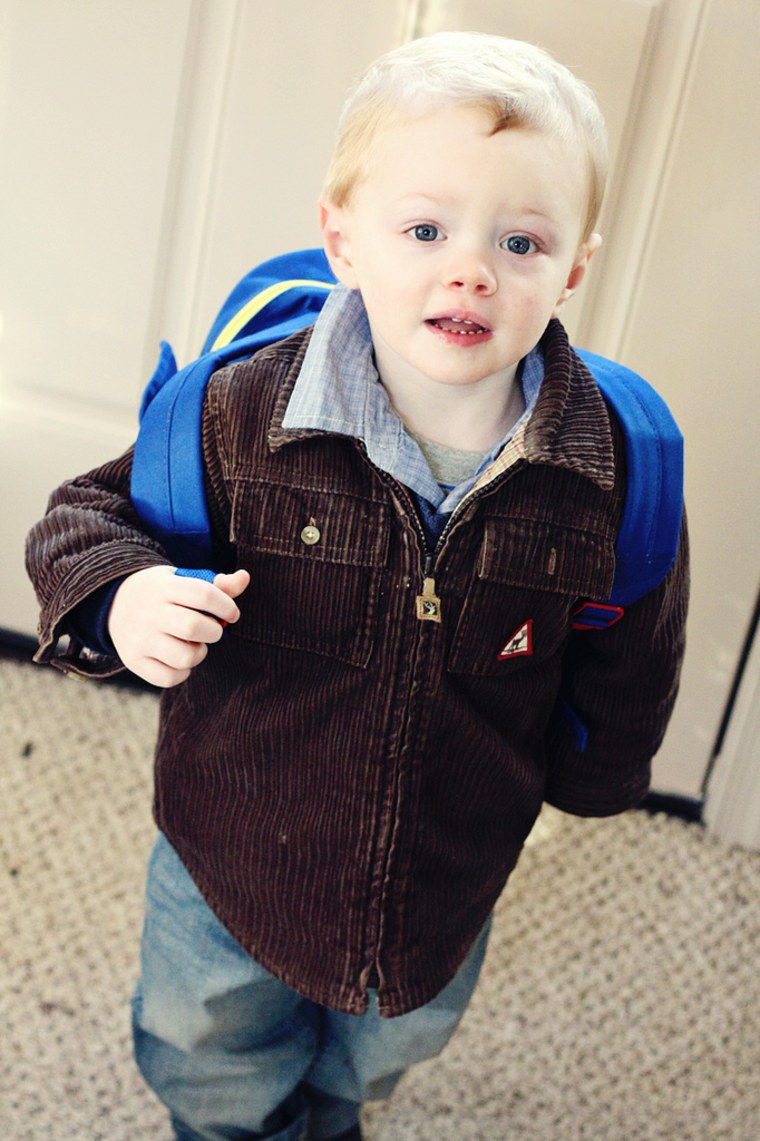 Little boy wearing backpack
