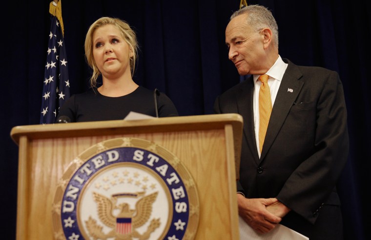 Image: Actress Amy Schumer becomes emotional during a news conference while her distant cousin, New York Sen. Chuck Schumer