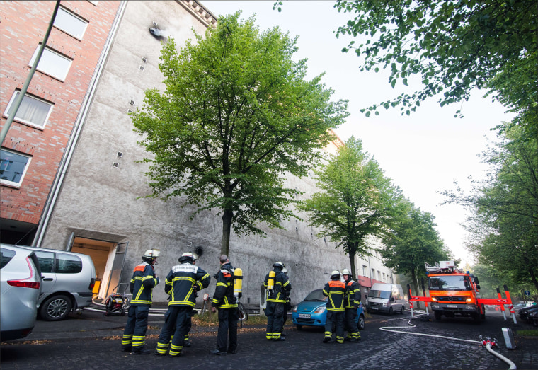Image: Firefighters stand outside the bunker in Hamburg, Germany