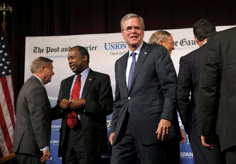 Image: U.S. Republican presidential candidate and former Florida Governor Jeb Bush walks out from among the pack of candidates after the conclusion of the Voters First Presidential Forum in Manchester