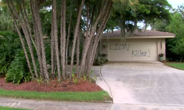 Image: Graffiti covers the garage door of the holiday home of dentist Walter Palmer on Marcos Island